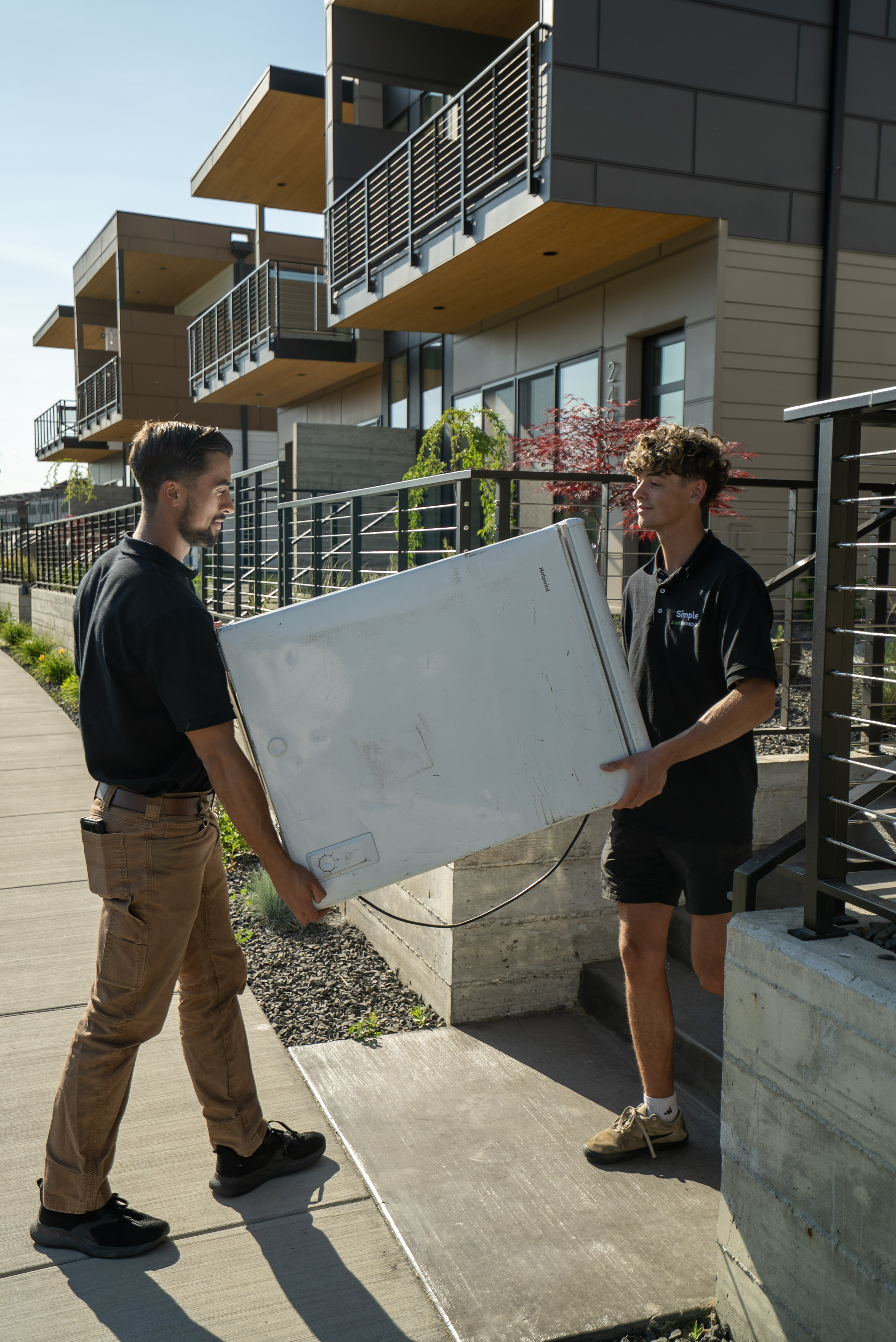 Frank and Romen carrying a refrigerator on a job in Spokane