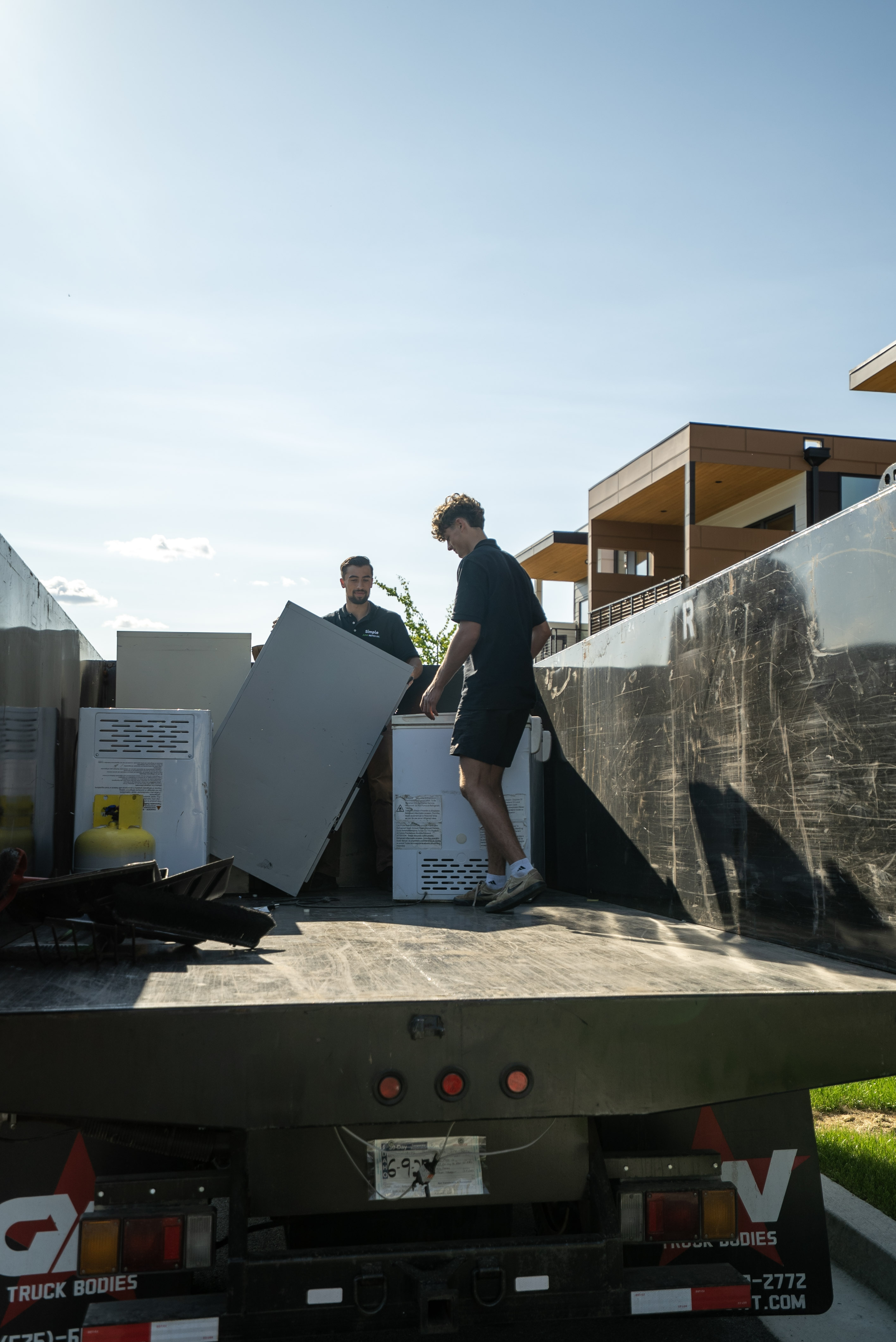 Loading appliances onto the Simple Junk Removal truck
